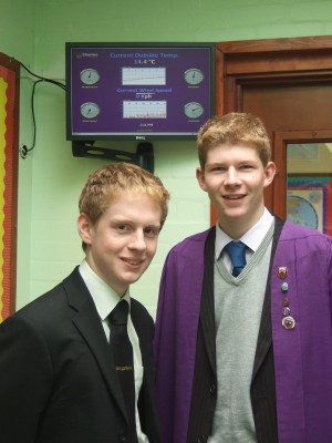 Pupils Frederick  Herzog, Head Boy and Jonathan Pescod in front of weather station monitor